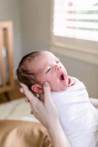 home newborn photos baby yawning
